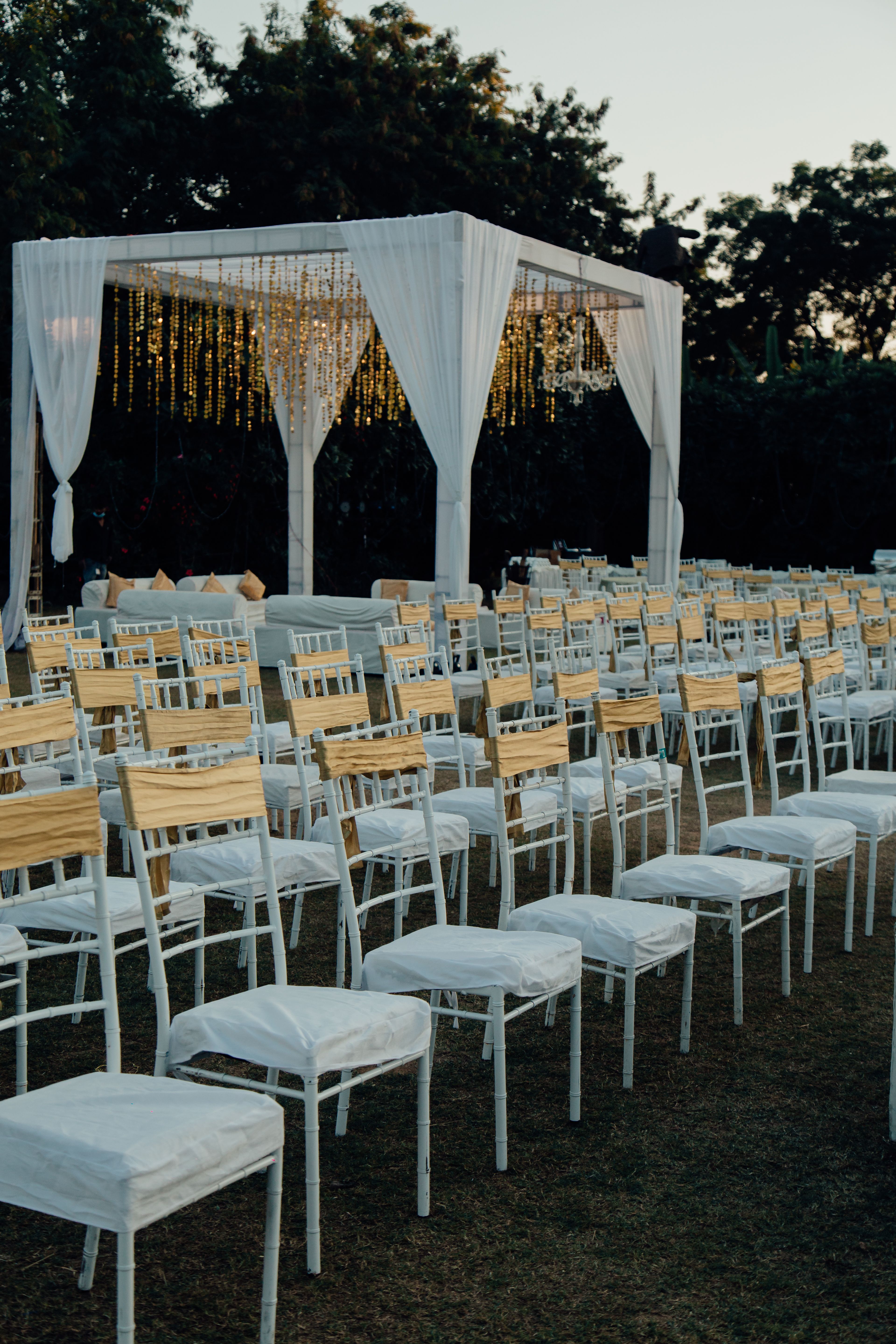 An evening mandap glowing with fairy lights, awaiting guests